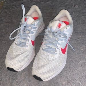 White downshifter running Nike shoes